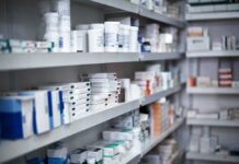 TrumpRx Slashes Prices—Why The Outrage? Shelves filled with various medication boxes and containers in a pharmacy