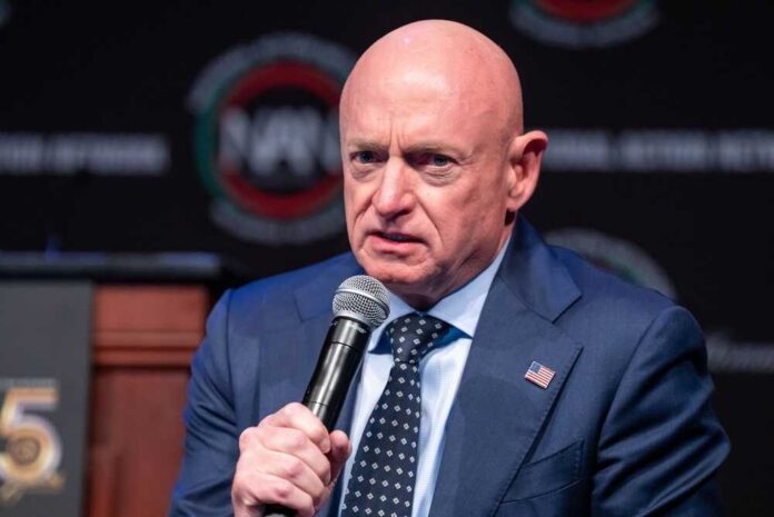 Man in a suit speaking into a microphone at a conference
