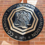 Emblem of the Commodity Futures Trading Commission mounted on a brick wall