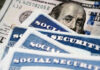 Social security cards with one hundred dollar bill