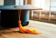 Governor’s Commencement Message: More Government Jobs! Graduation cap with yellow tassel on table