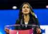 Person speaking at a podium during an event.