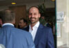 Foreign Squeeze Backfires: Bolsonaro Son Jailed Man in blue suit smiling in a group setting