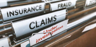 File folders labeled insurance, fraud, claims, investigation.