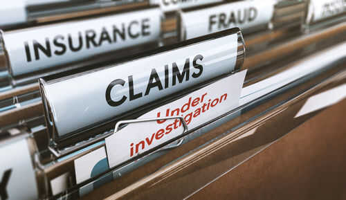 insurance-fraud-720284965 File folders labeled insurance, fraud, claims, investigation.