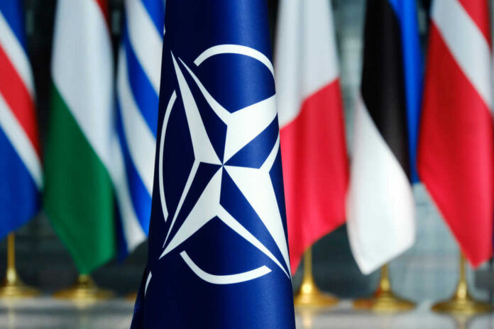 Flags',Of,Members,Of,Nato,At,The,Nato,Headquarters,In NATO flag in front of various national flags