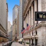 Amazon Tops Fortune 500, Overtakes Walmart View of Wall Street with skyscrapers and American flags