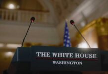 White House Adds “Leftist Influencers” to Media Offenders Page Podium with microphones at the White House for a press conference