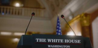 Podium with microphones at the White House for a press conference
