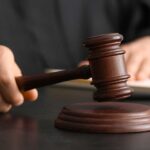 Tap-To-Delete Sparks 20-Year Nightmare A judge's hand holding a gavel above a wooden block
