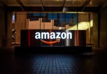 Illuminated Amazon logo on a building at night