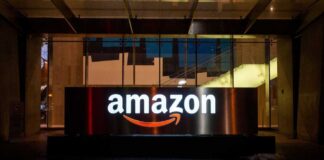 Illuminated Amazon logo on a building at night