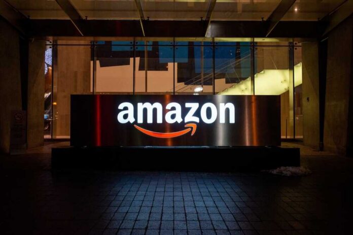 Illuminated Amazon logo on a building at night