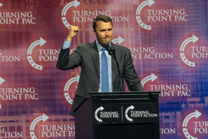 Duluth,,Georgia,,October,23,,2024.,Charlie,Kirk,,Founder,Of,Turning Speaker at podium raising a fist during a conference