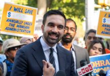 Ticket Gimmick Ignites NYC Backlash A man speaking at a rally with supporters holding protest signs