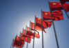Shock Doctrine: Speed Beats Armor In China’s Plan Multiple Chinese flags waving against a clear blue sky