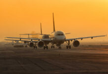 Runway Mix-Up Triggers Logan Panic Airplanes lined up on a runway during sunset