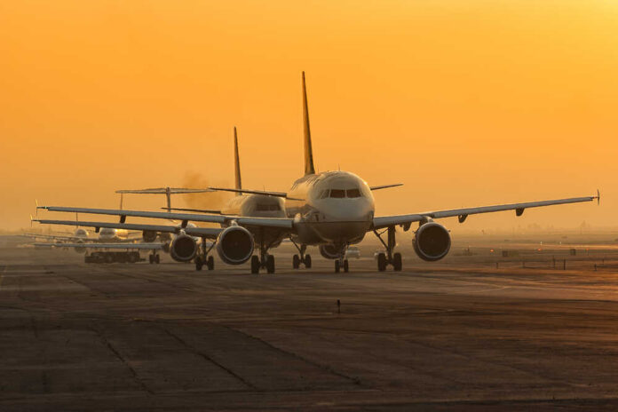 Mexico,City,Airport,Morning,Queue,For,Takeoff Airplanes lined up on a runway during sunset