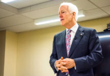 GOP Meltdown: Cornyn Warns ‘DISASTER’ A man in a suit delivering a speech in a conference room