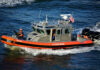 U.S. Coast Guard patrol boat speeding across the water