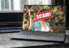 Laptop screen with a scam warning image.