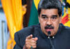 Man speaking passionately and gesturing during a speech.
