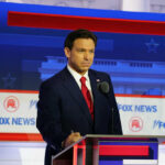 Man in suit speaking at Fox News event.