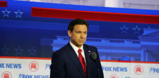 Man in suit speaking at Fox News event.