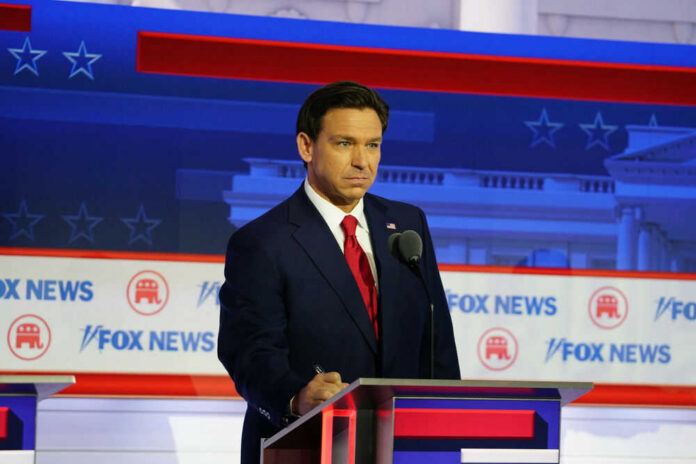 Man in suit speaking at Fox News event.