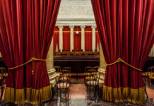 Kagan’s Seat Hinged On A Punchline Man sitting at a desk with nameplate Sen Graham