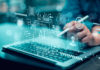 Silicon Valley Lockout Plan Emerges Person using stylus on laptop with AI and cybersecurity icons overlay