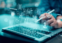Silicon Valley Lockout Plan Emerges Person using stylus on laptop with AI and cybersecurity icons overlay