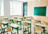 Classroom Shock: Lifelike ‘Teacher’ From Adult Brand Empty classroom with desks facing a chalkboard