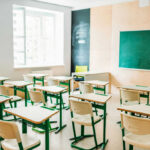Classroom Shock: Lifelike ‘Teacher’ From Adult Brand Empty classroom with desks facing a chalkboard