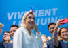 Convicted—But Running: France Erupts Group taking selfie with smiling woman at event