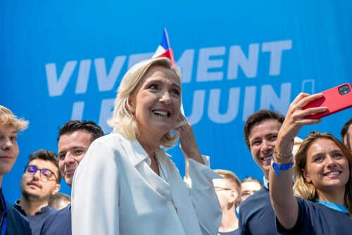 Group taking selfie with smiling woman at event