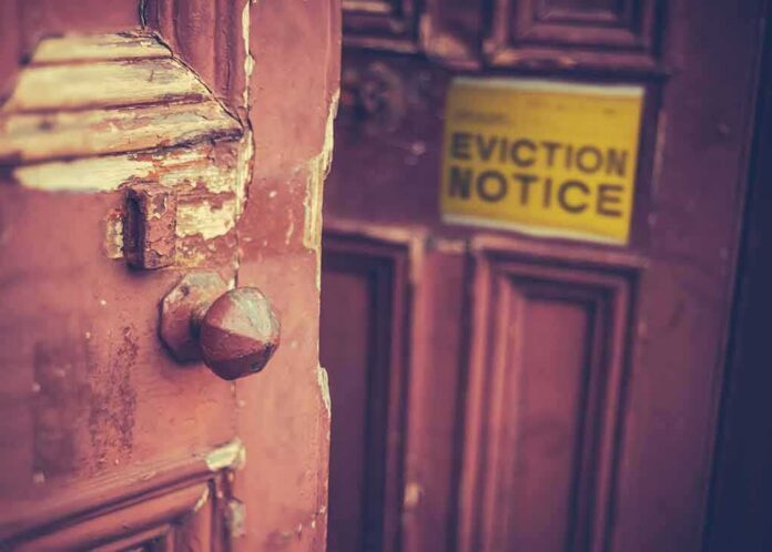 Weathered wooden door with eviction notice