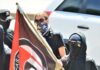 Texas Verdicts Shatter ‘No Antifa Terror’ Claim Masked protesters holding a black and red flag