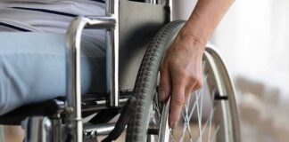 Hand on wheelchair wheel