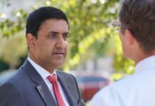 Two professionals engaged in conversation outdoors
