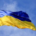 Sea Lanes Snarled — Putin’s Crimea Problem Ukrainian flag waving on a flagpole against blue sky