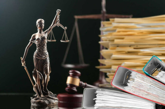 supremecourt-id2274157631jpg Lady Justice statue beside gavel and stacks of legal files