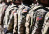 Congress Quietly Bets On China-Buster Soldiers in camouflage with American flag patches standing