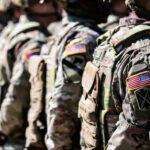 Congress Quietly Bets On China-Buster Soldiers in camouflage with American flag patches standing