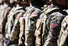 Congress Quietly Bets On China-Buster Soldiers in camouflage with American flag patches standing