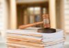 Slick 15% Claim Now Haunts Cardone judge's gavel resting on a stack of case files