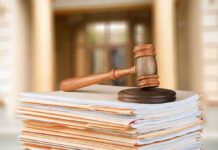 Slick 15% Claim Now Haunts Cardone judge's gavel resting on a stack of case files