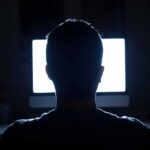Contractor Threat Leads to Gut-Punch Discovery person silhouetted in front of a bright computer screen