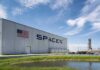 Gulf Coast Shake-Up: SpaceX Moves In SpaceX hangar beside launch pad under blue sky