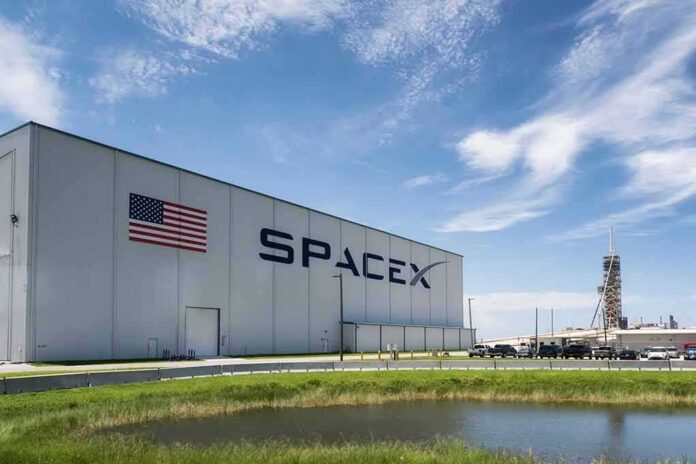 SpaceX hangar beside launch pad under blue sky